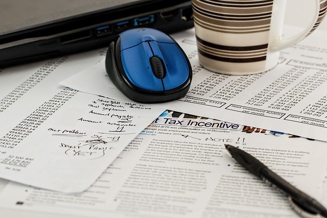 a computer mouse on some accounting documents